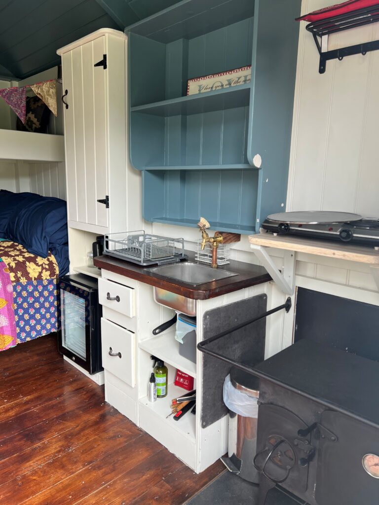 tree shepherds hut interior kitchenette